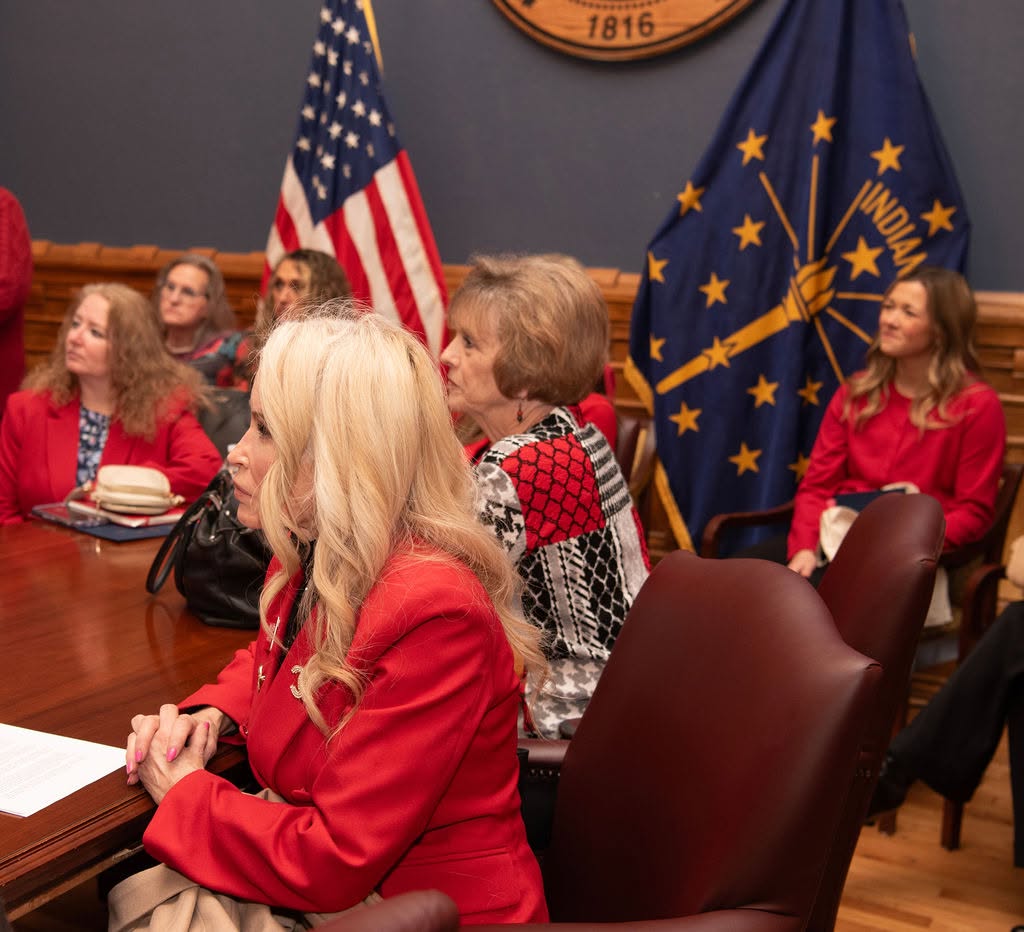 IFRW members in red seated in an Indiana Statehouse committee room during session