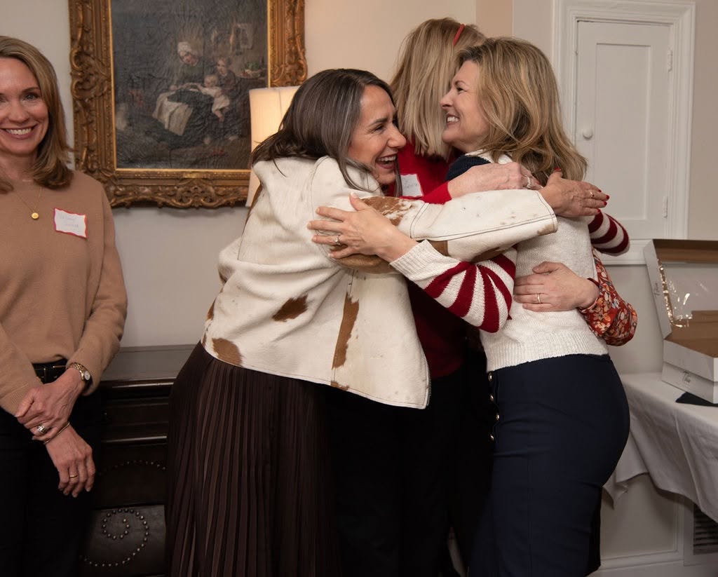 Two IFRW members embracing warmly at a club gathering