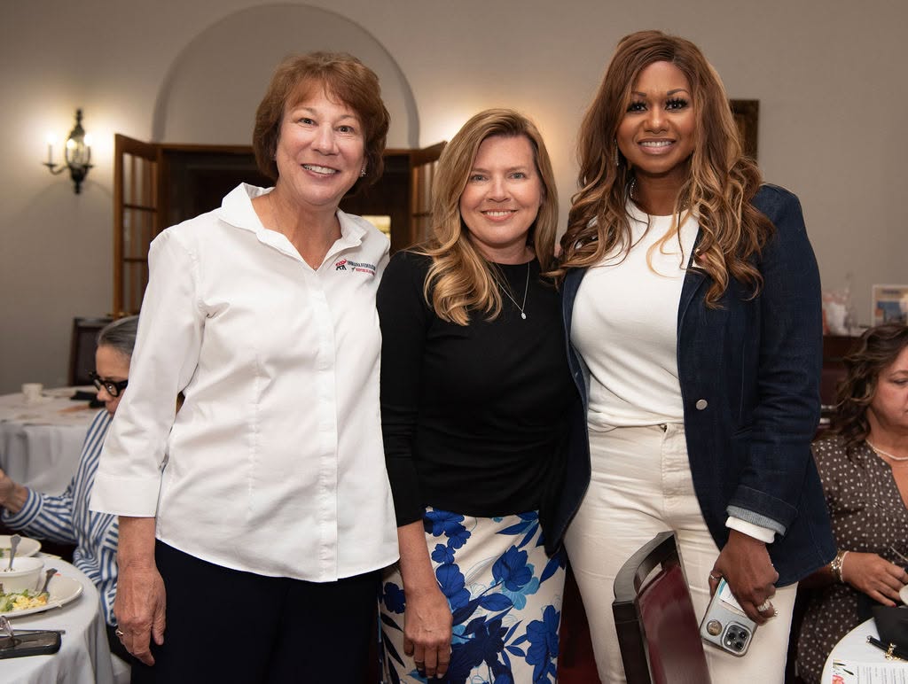 Three IFRW members smiling together at a federation luncheon