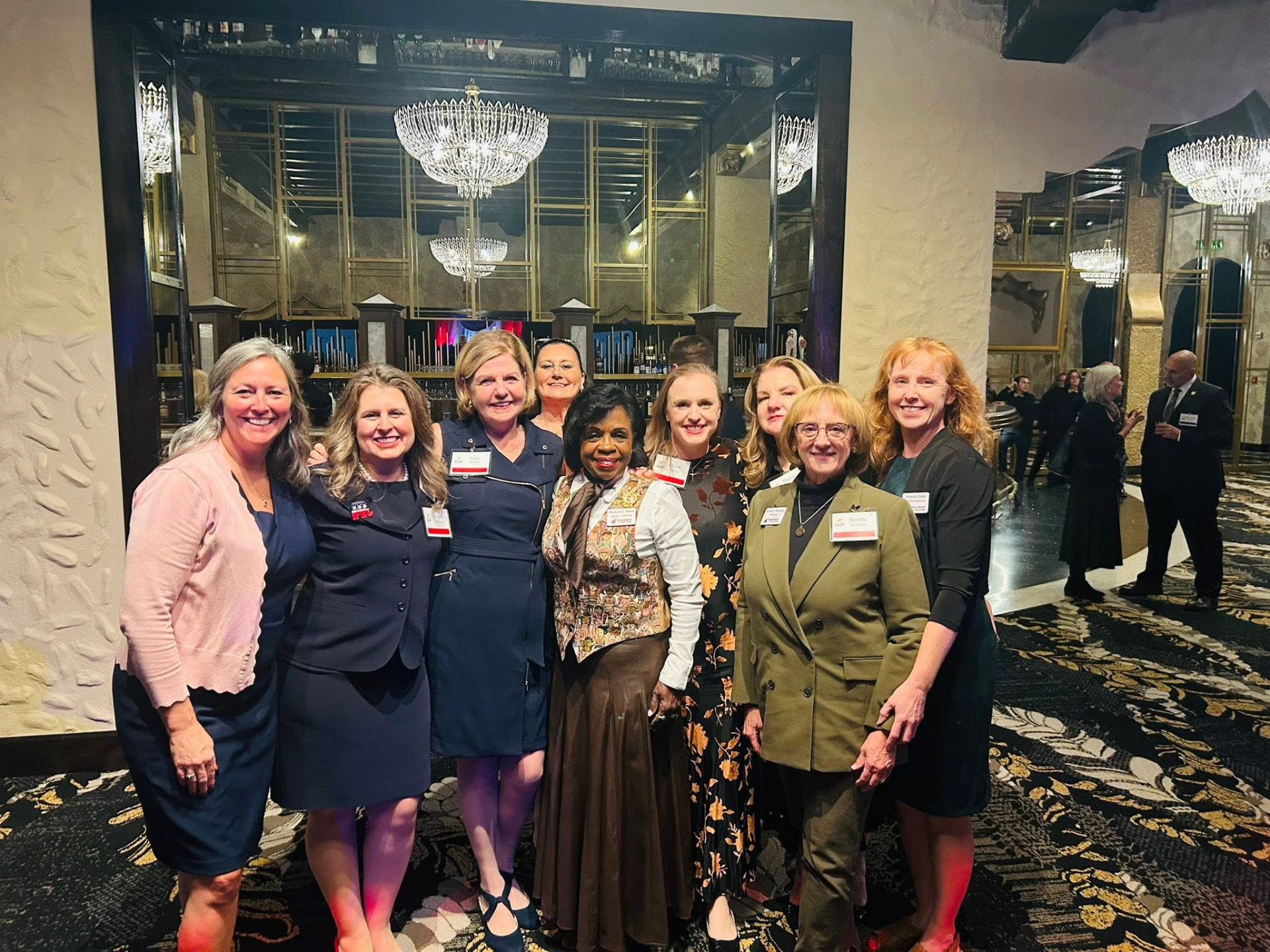 IFRW officers and members together at an evening reception in a chandelier-lit ballroom